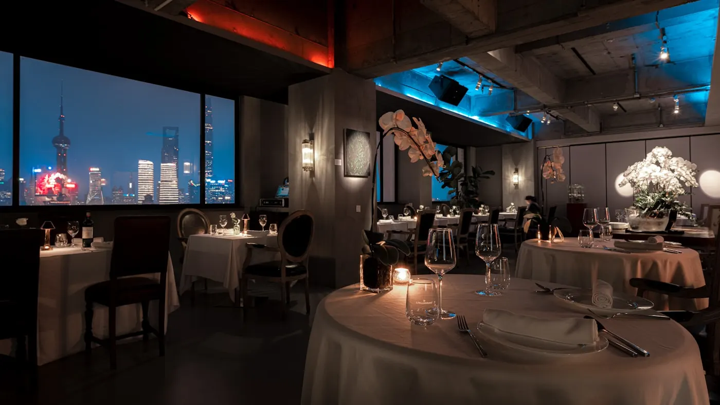 Candlelit dining room of a farm-to-table restaurant